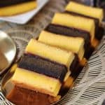 A few slices of Lapis Surabaya cake on a golden plate.