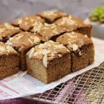 Several Dutch ontbijtkoek slices on parchment paper and wire rack.