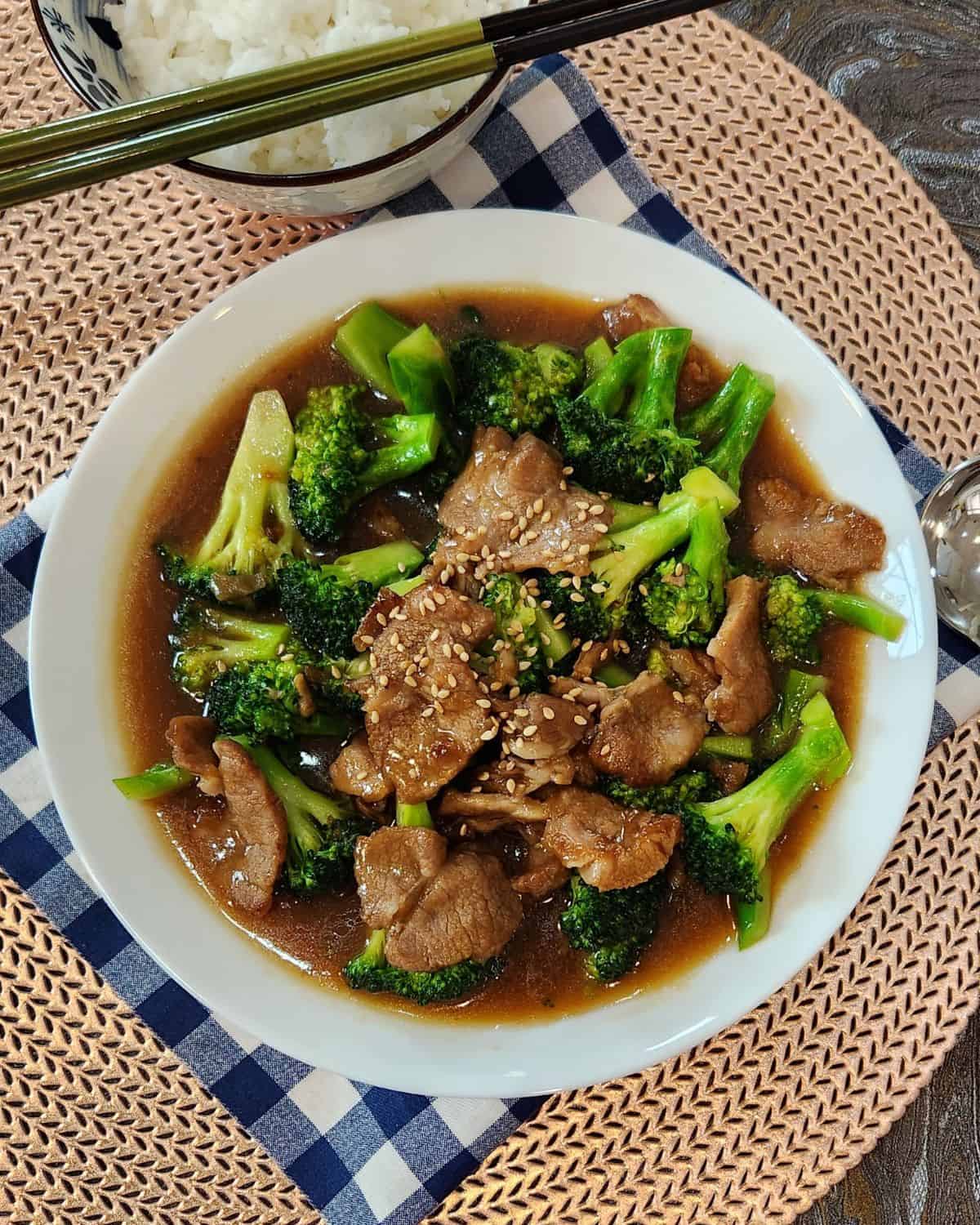A plate of pork and broccoli stir fry.