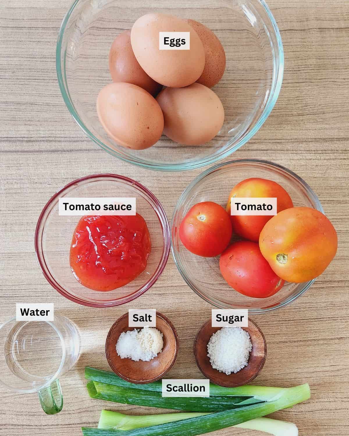 Tomato egg stir fry ingredients with labels.