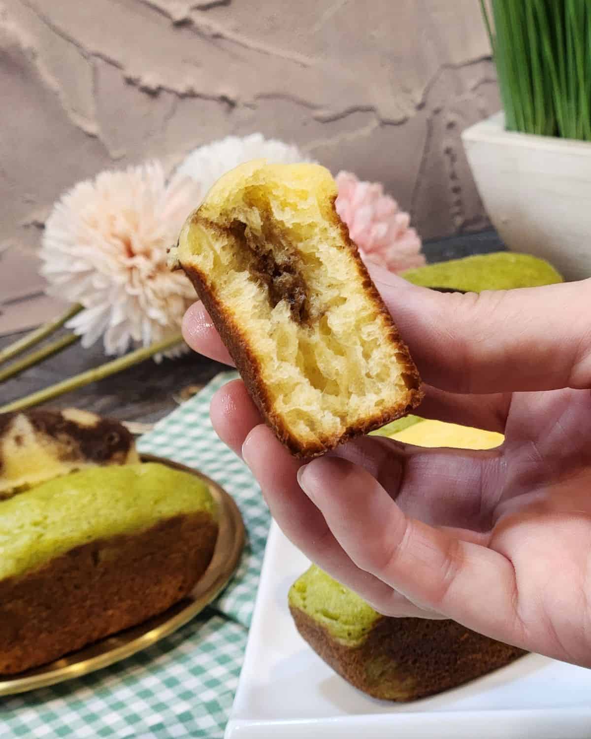 Half of a pukis cake revealing the texture inside.