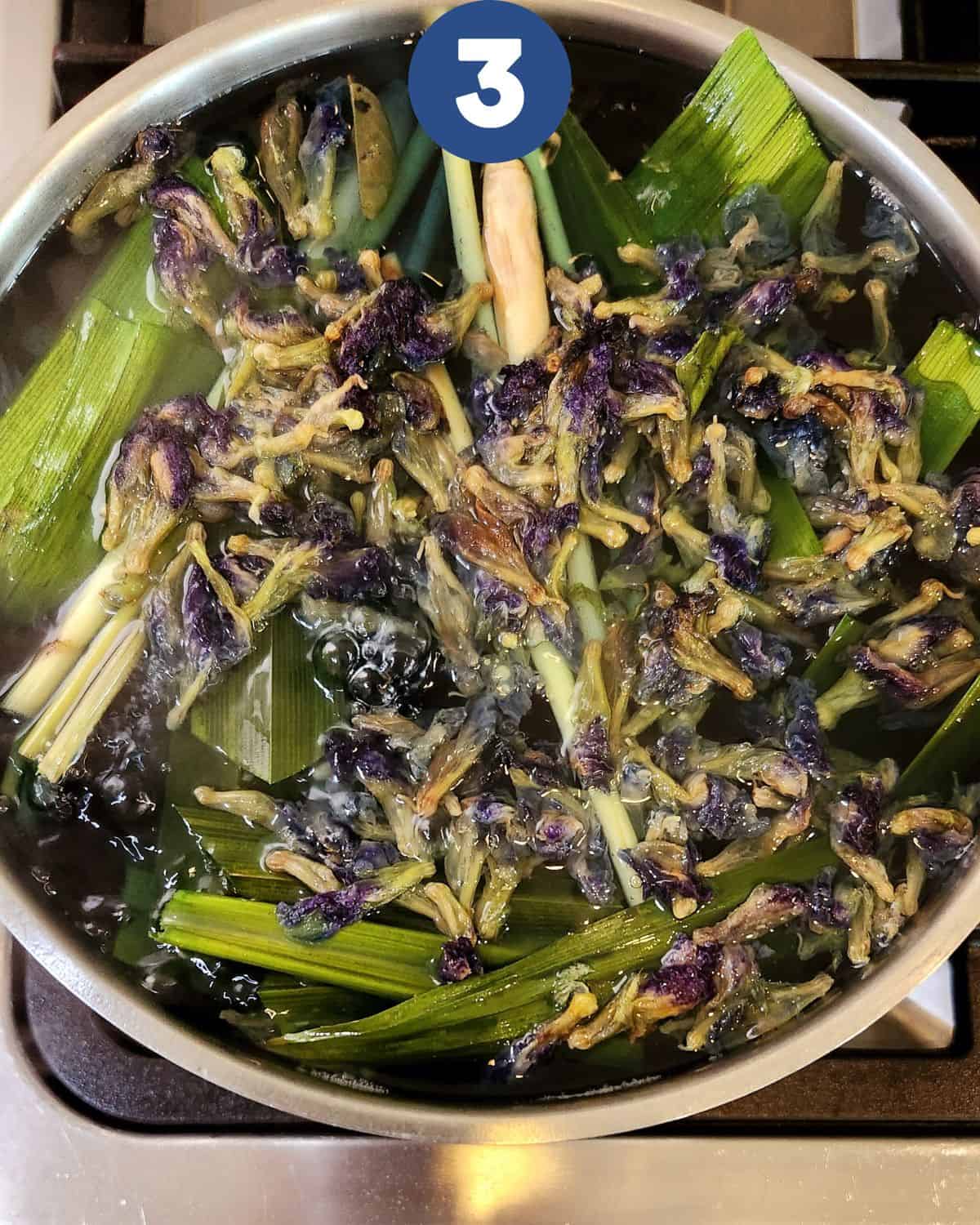 Process photos of brewing butterfly pea tea until the flowers change color.