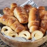 A stack of Salt Bread in a wooden basket.