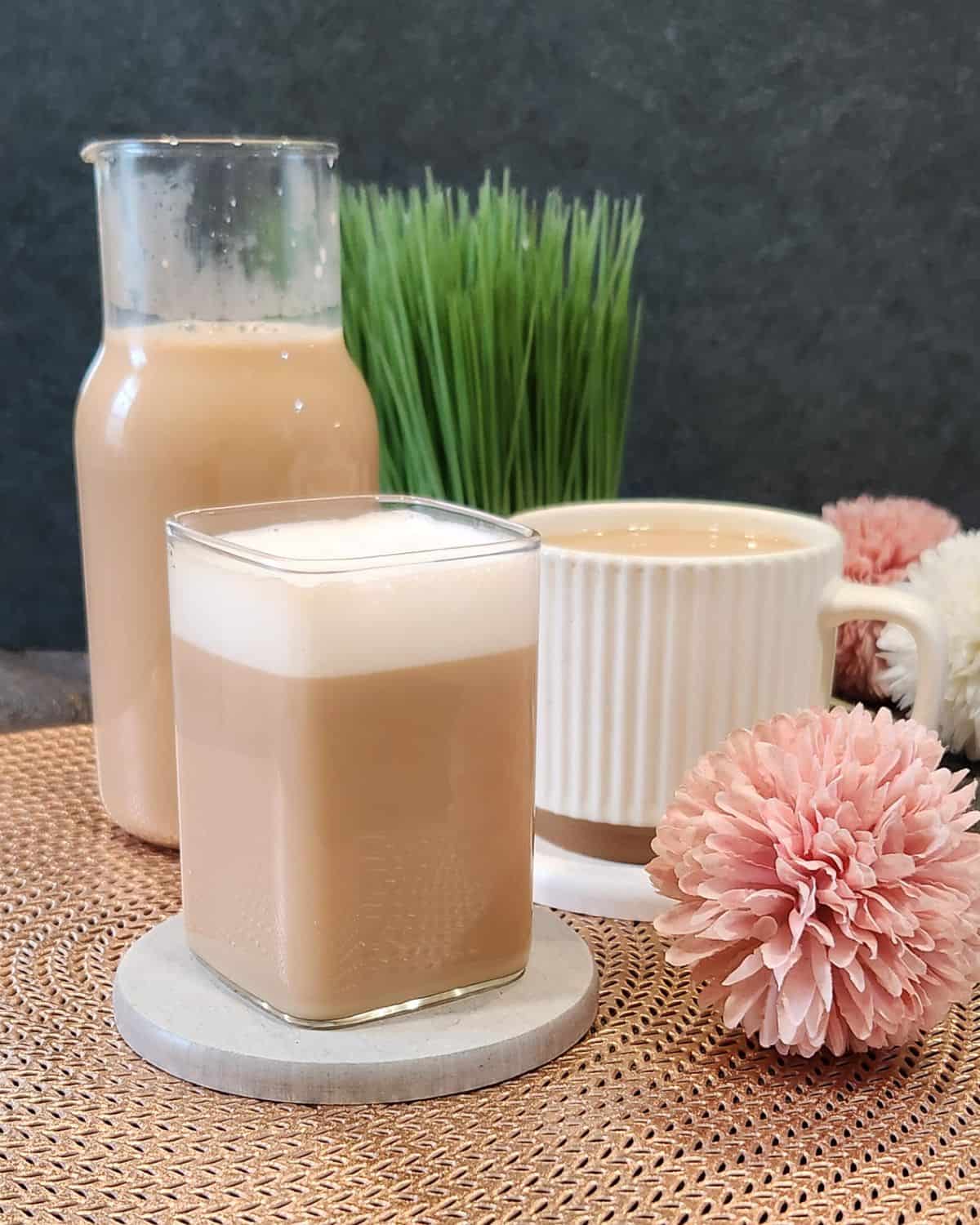 A glass of warm London Fog or Earl Grey milk tea with milk froth on top. 