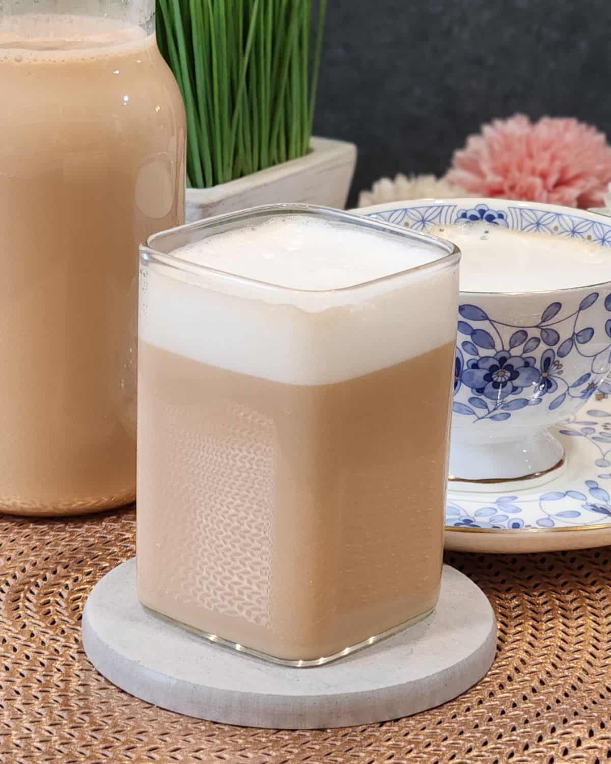 A glass of earl grey milk tea or London fog with milk froth on top.