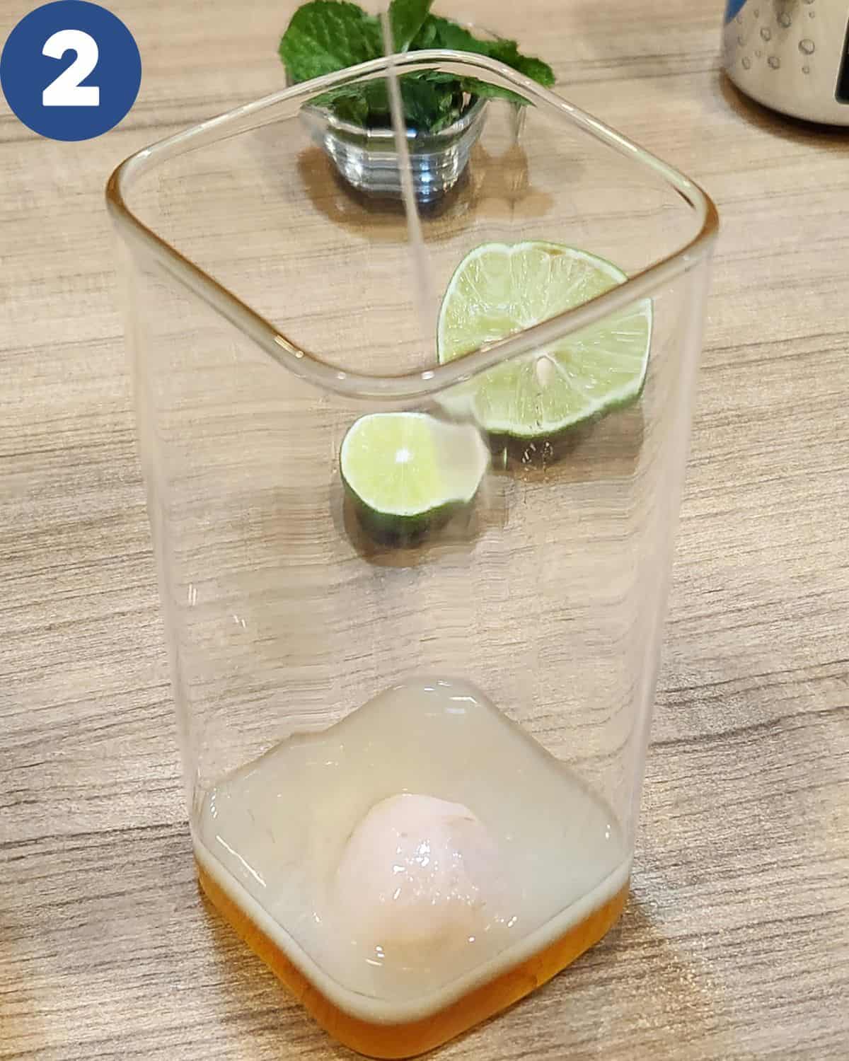 Pouring lime juice into a serving glass.