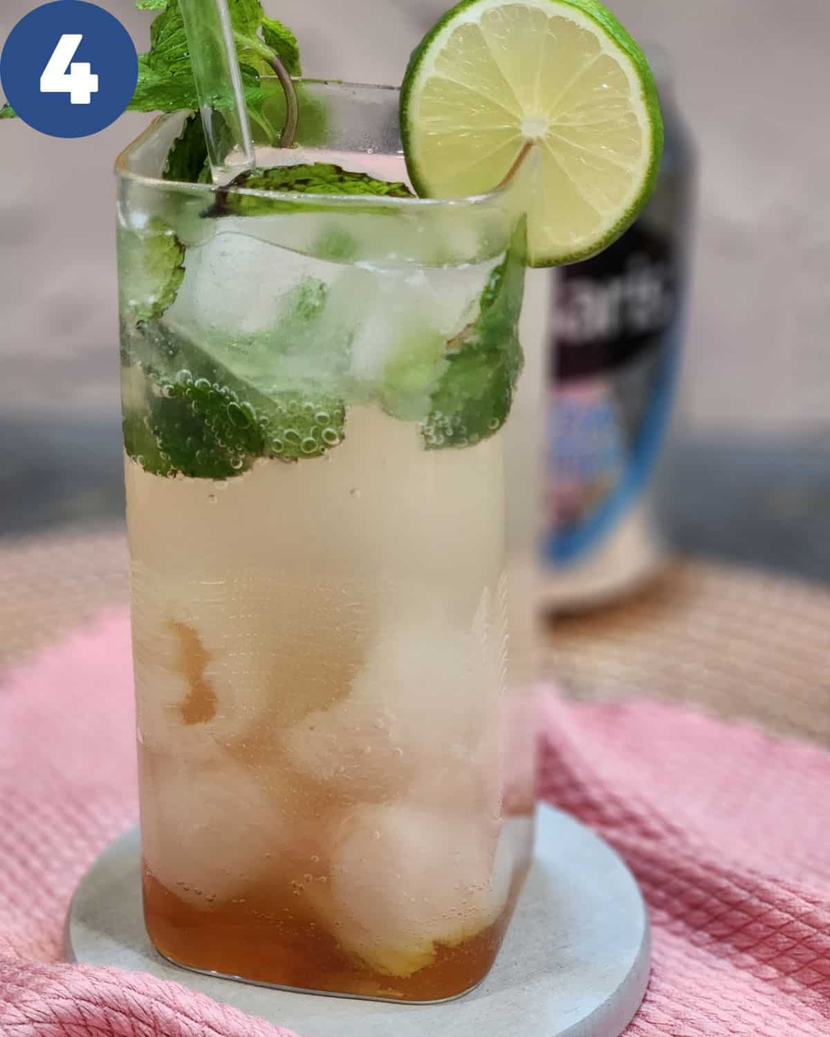 Adding ice cubes, lime slices,and mint leaves for garnish.