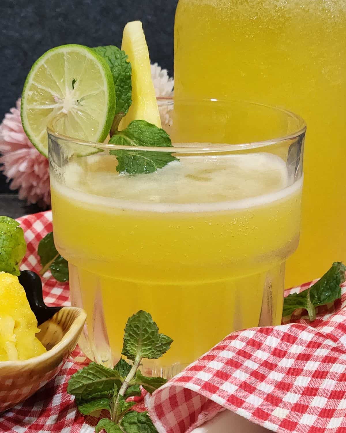 A glass of cold pineapple mint soda.