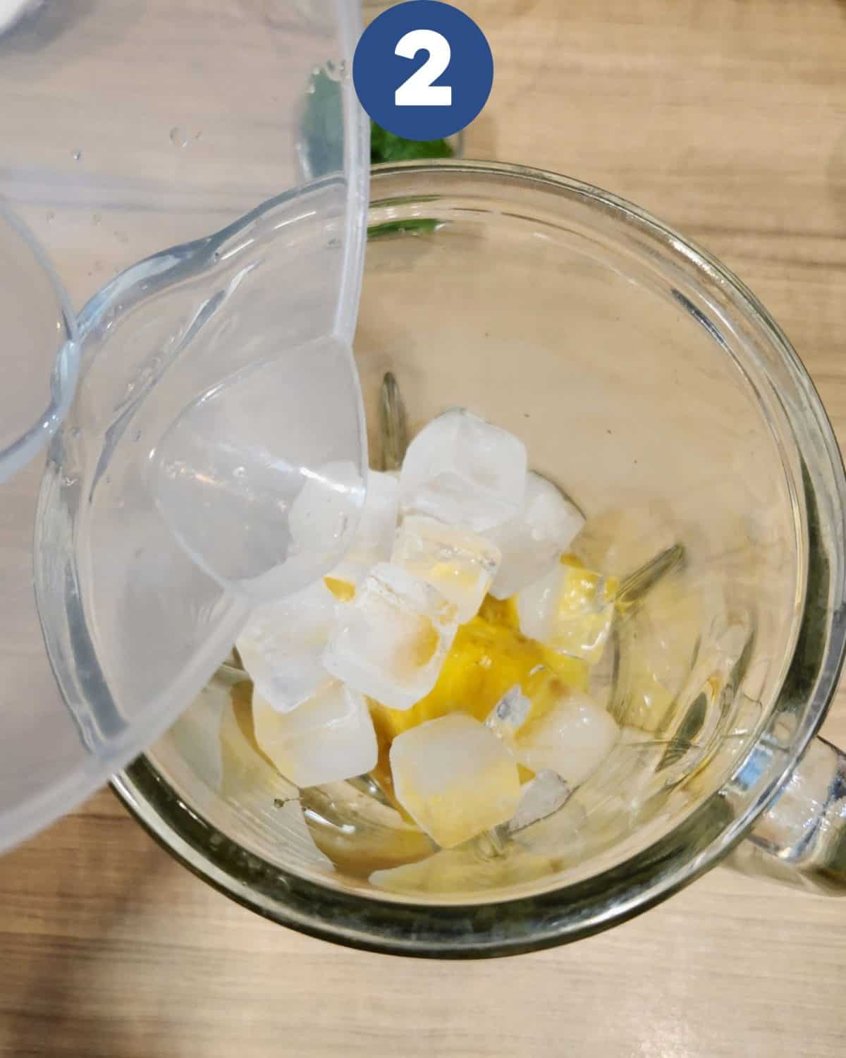 Preparing to blend pineapple with lime juice, ice cubes mint leaves, and water.