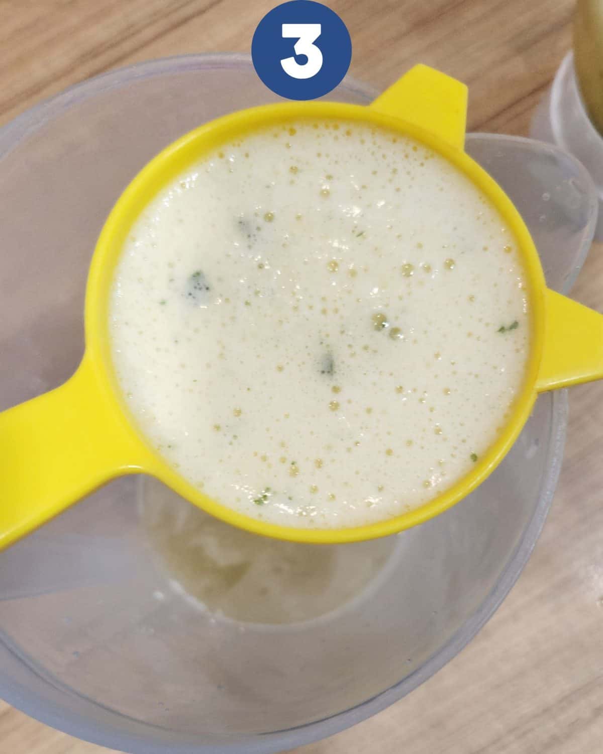 Straining the pineapple, mint leaves, and lime juice.