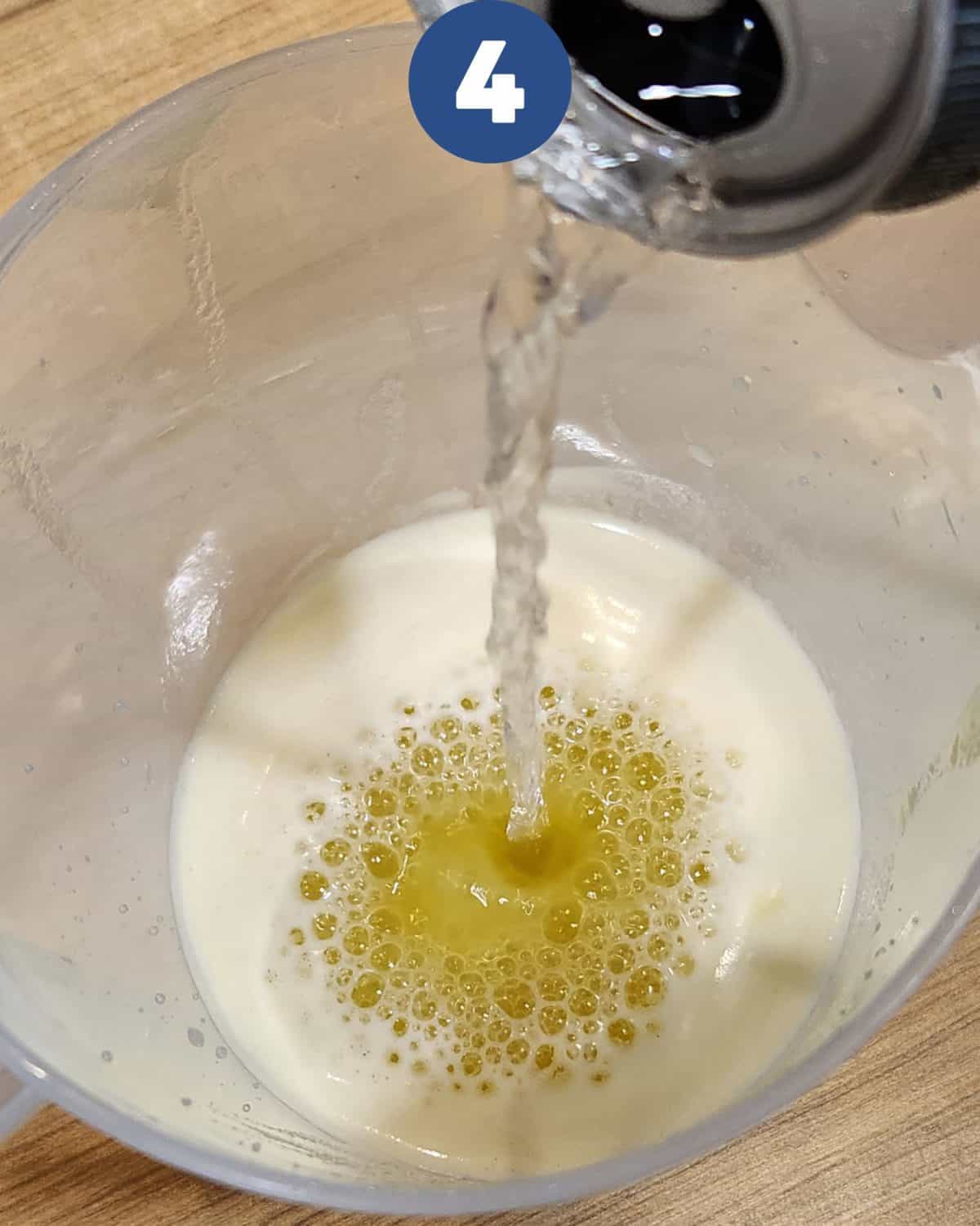 Adding soda water to the pineapple mint juice.