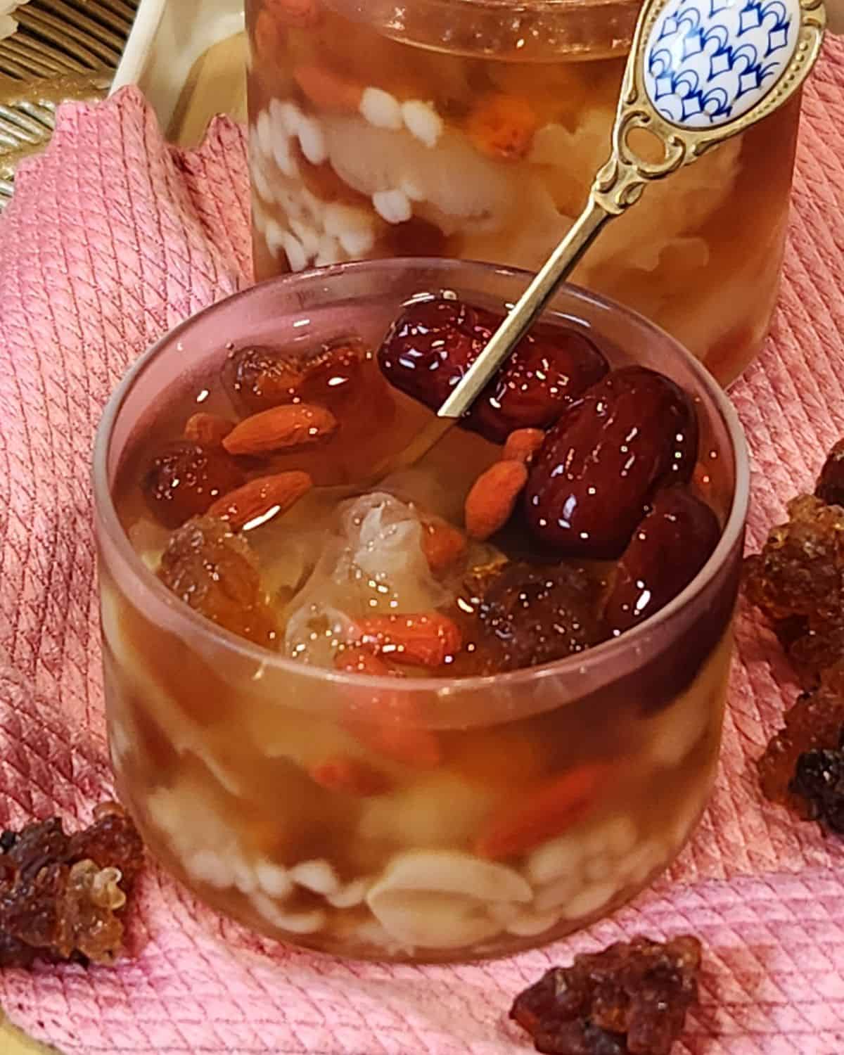 A glass of peach gum dessert (tong sui) or snow fungus dessert served cold.