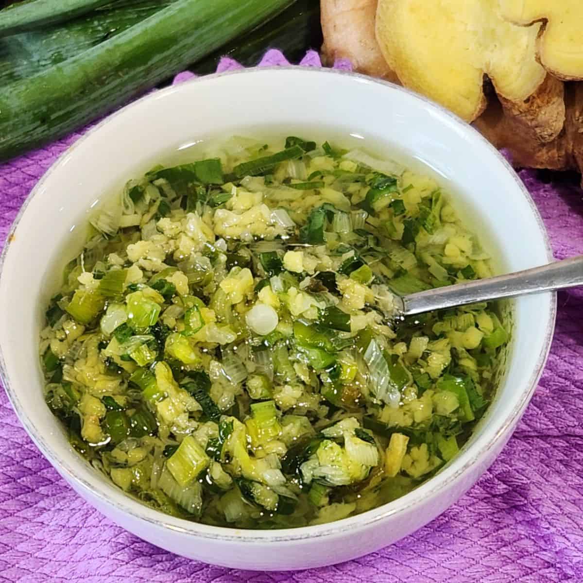 A bowl full of ginger scallion sauce.