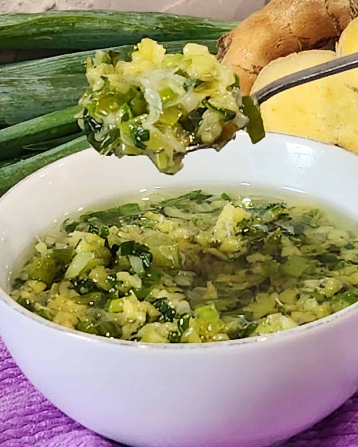 A small spoon scooping ginger scallion sauce.