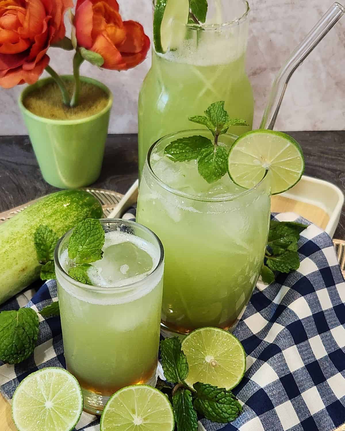 A cold glass of cucumber juice drink with lime and mint leaves. 