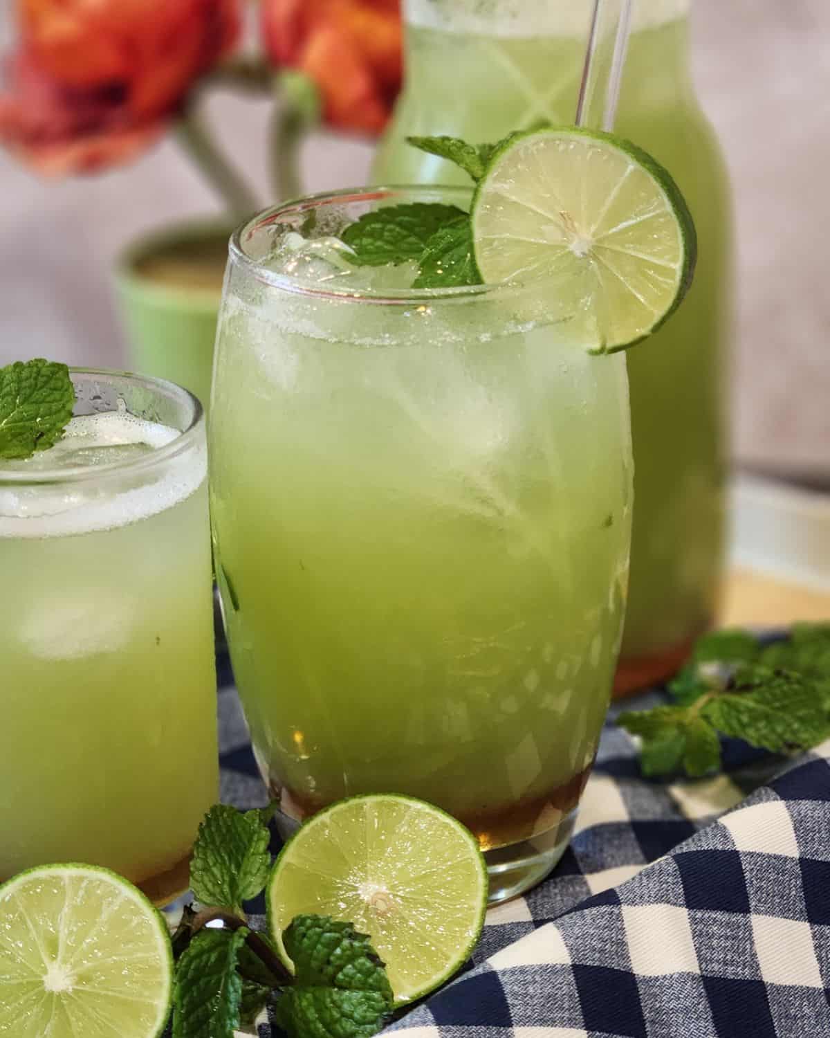 A cold glass of cucumber juice drink with lime and mint.