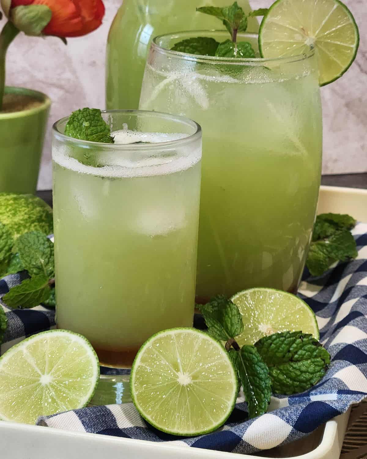 A cold glass of cucumber juice drink with lime and mint.