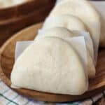 Taiwanese Bao Buns on a wooden plate.