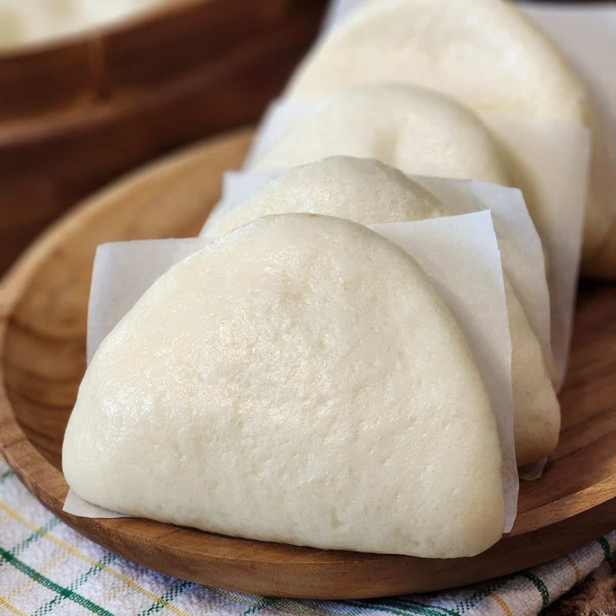 Taiwanese Bao Buns on a wooden plate.