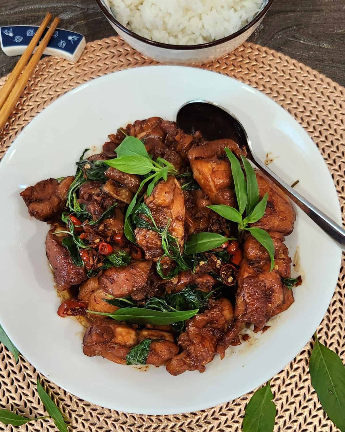 A plate of Taiwanese three cup chicken with basil and chilis.