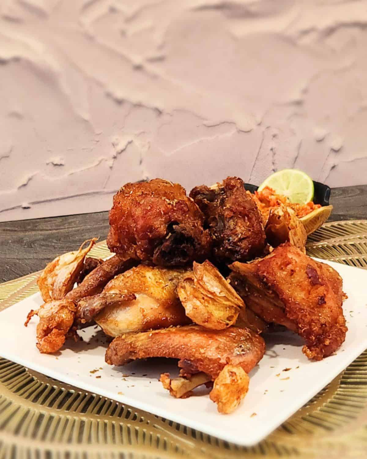 A few pieces of garlic fried chicken on a plate.