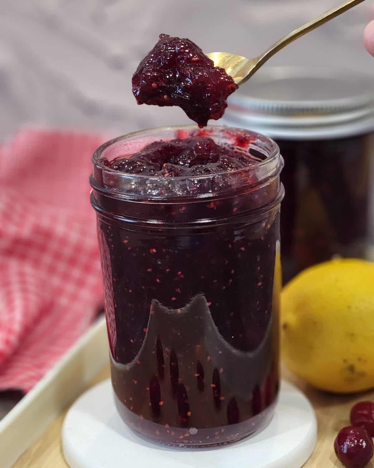 A teaspoon of thick cranberry jam on top of the jar.