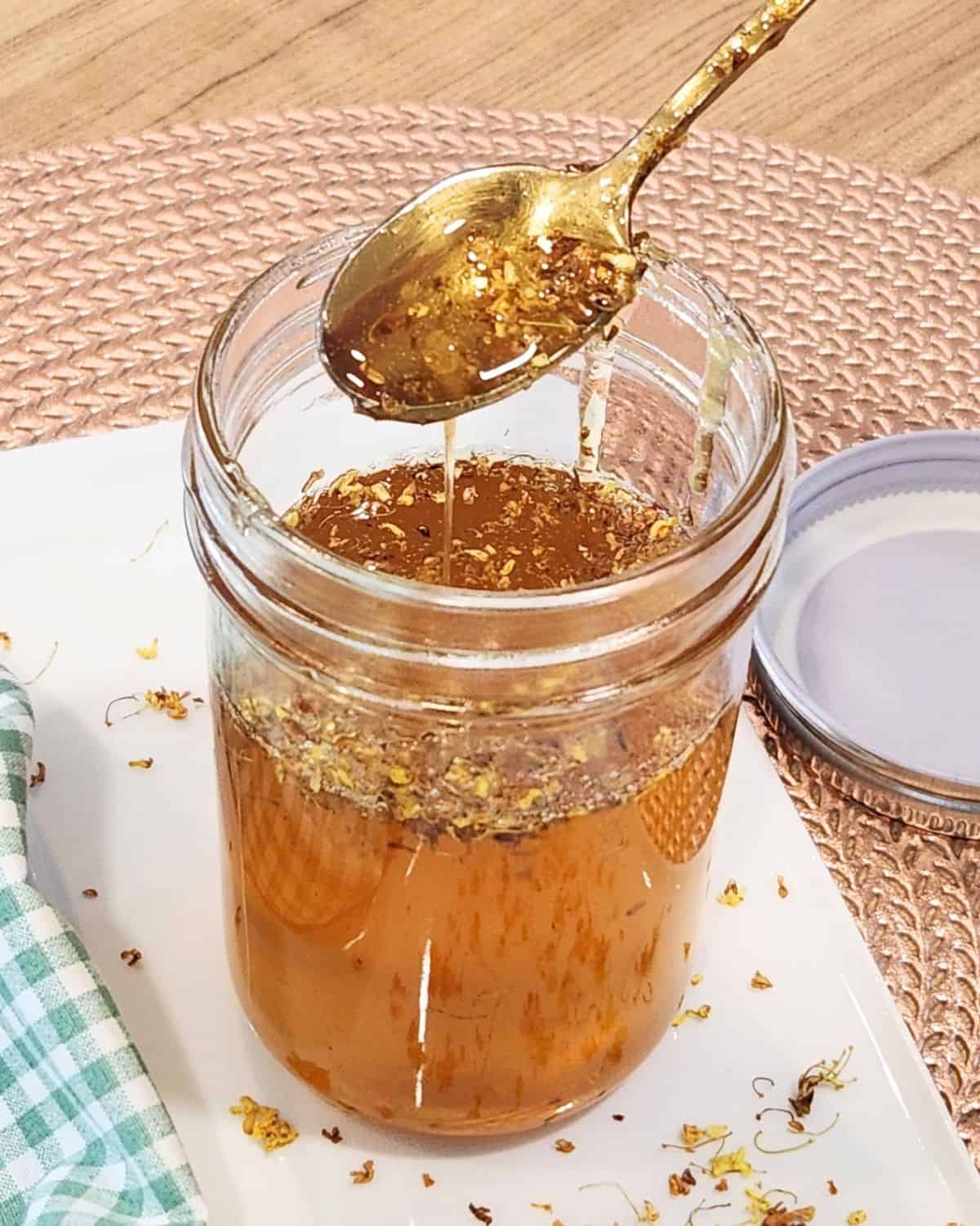 A spoon on top of osmanthus syrup jar.